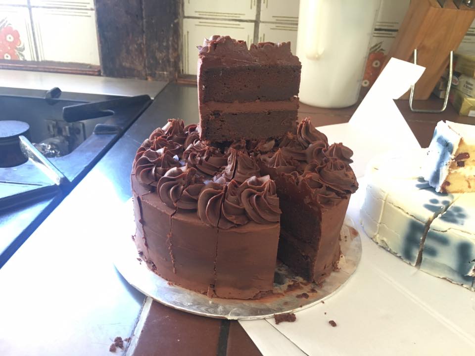 A sticky dark chocolate cake with lots of chocolate ganache